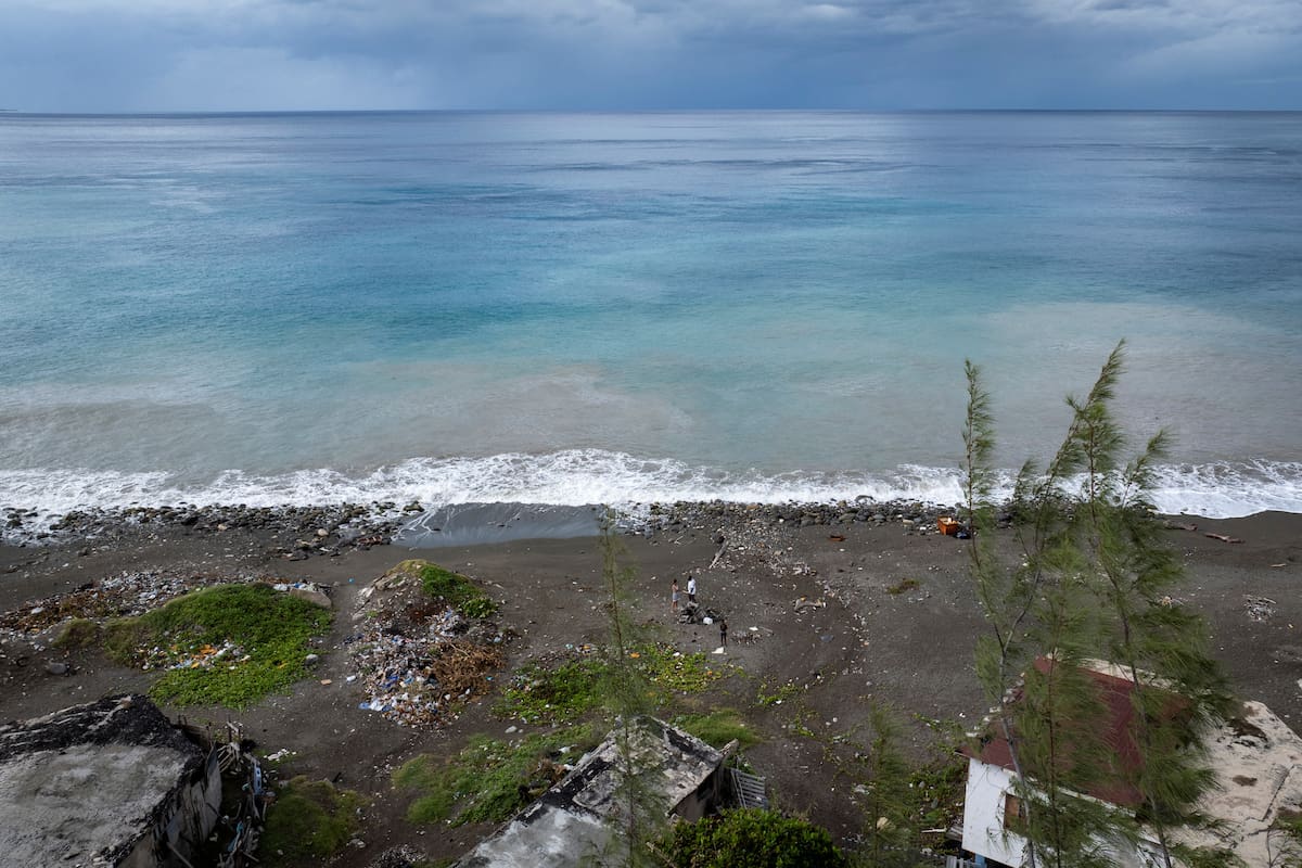 Varias personas permanecen en la costa del barrio de Caribbean Terrace mientras se aproxima el huracán Beryl, en Kingston, Jamaica
July 3, 2024. REUTERS/Marco Bello